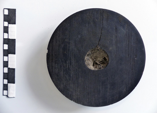 A wooden sheave as prepared for documentation and storage or display