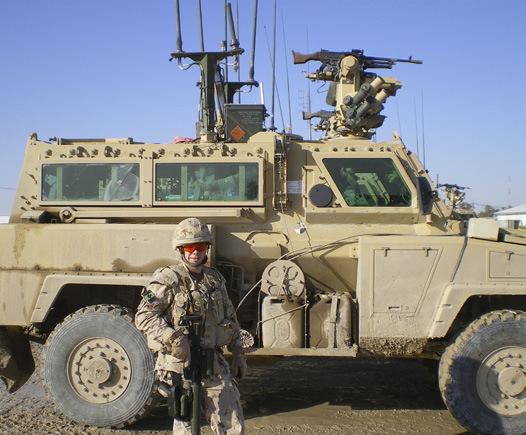 Captain Stocker with armoured vehicle in Afghanistan