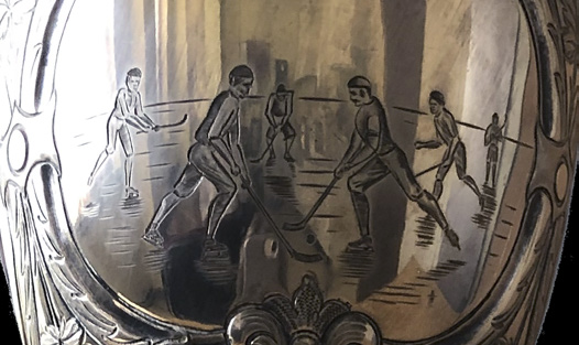 Engraved scene on the Cosby Cup showing hockey action