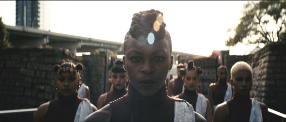 Esie Mensah and her dancers meet the gaze of the viewer